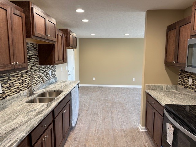 1427 Old Estill Springs Road Tullahoma, TN 37388 - Photo 15 of 44 a kitchen with stainless steel appliances granite countertop a sink stove and refrigerator