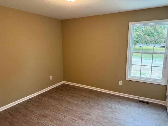 1427 Old Estill Springs Road Tullahoma, TN 37388 - Photo 19 of 44 a view of an empty room with wooden floor and a window