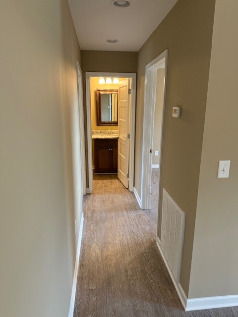 1427 Old Estill Springs Road Tullahoma, TN 37388 - Photo 20 of 44 a view of a hallway with wooden floor and a refrigerator