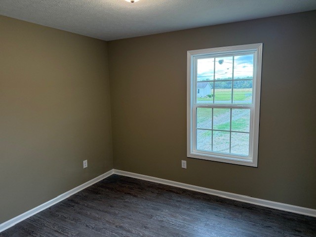 1427 Old Estill Springs Road Tullahoma, TN 37388 - Photo 21 of 44 an empty room with wooden floor and windows