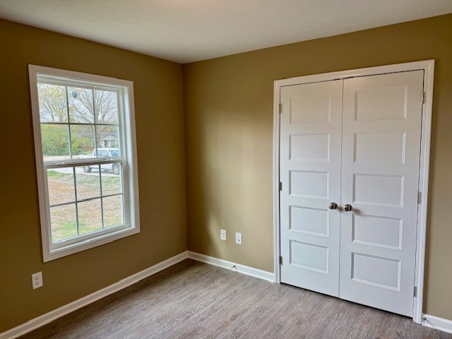 1427 Old Estill Springs Road Tullahoma, TN 37388 - Photo 39 of 44 an empty room with wooden floor and closet area