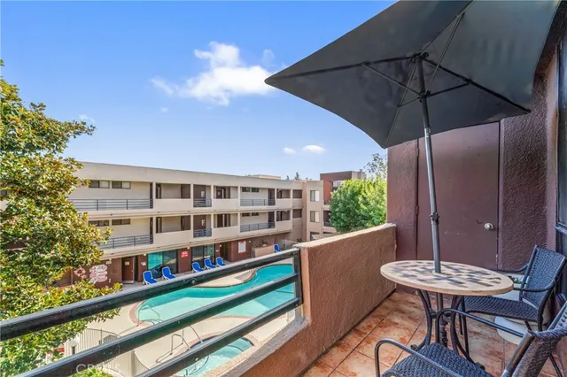 a view of a balcony with chairs and a table