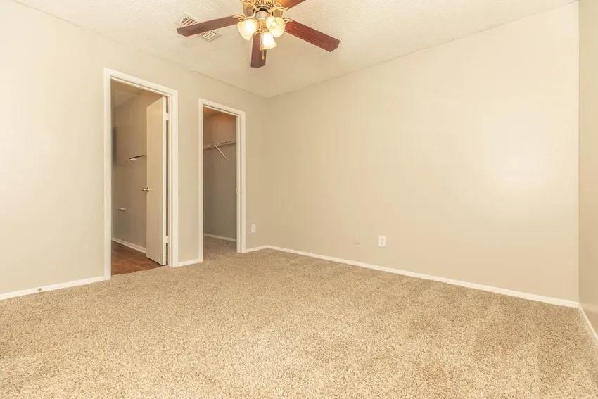 6897 Meadow Road North Richland Hills, TX 76182 - Photo 2 of 13 an empty room with a chandelier fan