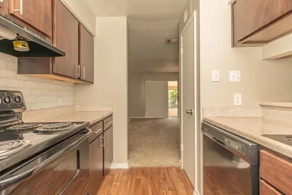 a kitchen with granite countertop a stove and a sink
