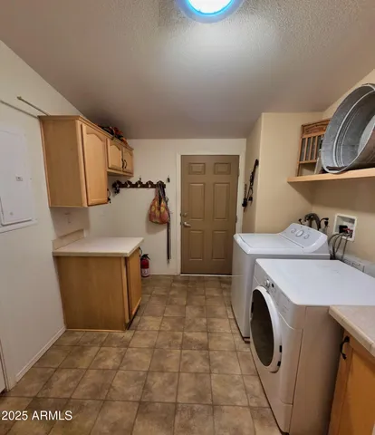 a utility room with sink dryer and washer