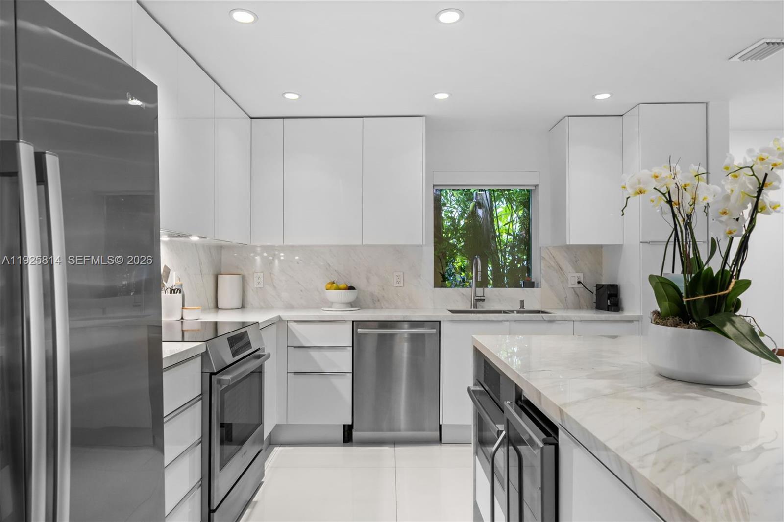45 Southwest 19th Road Miami, FL 33129 - Photo 11 of 56 a kitchen with a sink a stove and cabinets