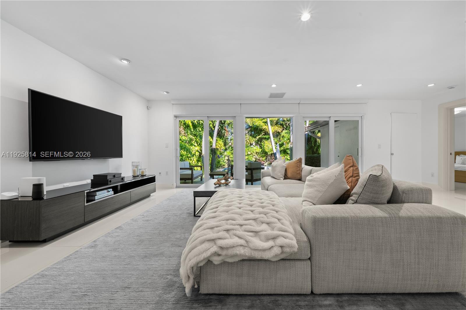 45 Southwest 19th Road Miami, FL 33129 - Photo 15 of 56 a living room with furniture and a flat screen tv