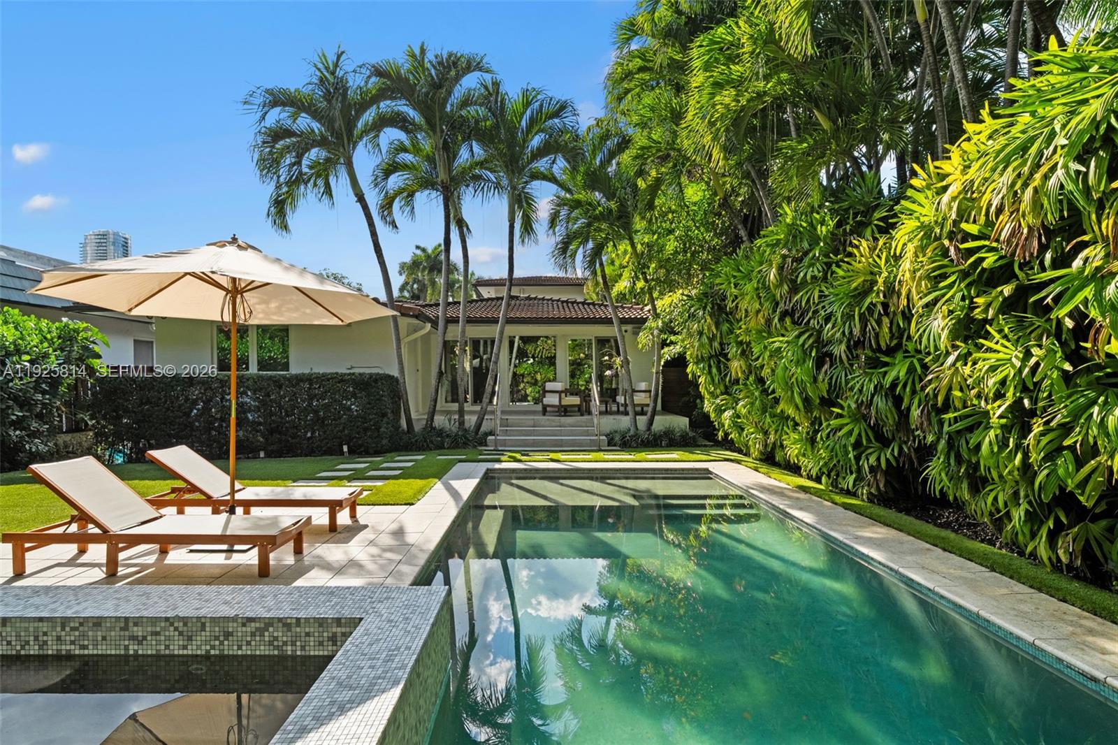 45 Southwest 19th Road Miami, FL 33129 - Photo 19 of 56 a view of swimming pool with chairs and umbrella