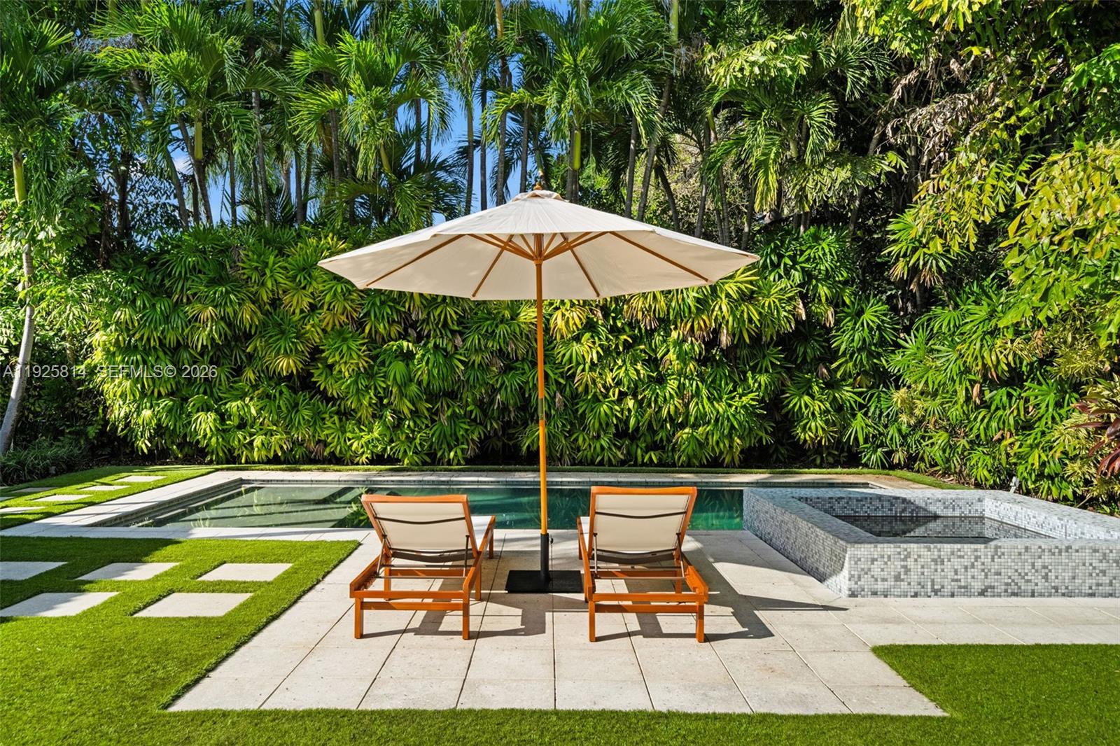 45 Southwest 19th Road Miami, FL 33129 - Photo 33 of 56 a lawn chairs sitting under a blue umbrella