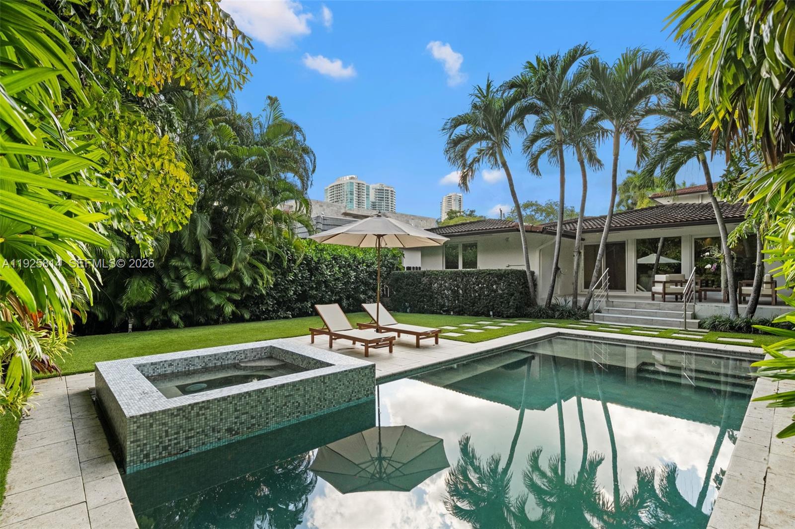 45 Southwest 19th Road Miami, FL 33129 - Photo 46 of 56 a view of a swimming pool with a lounge chairs