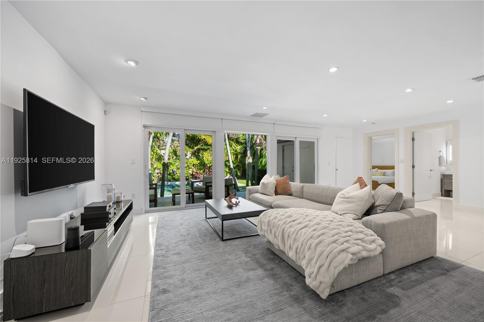 45 Southwest 19th Road Miami, FL 33129 - Photo 5 of 56 a living room with furniture and a flat screen tv