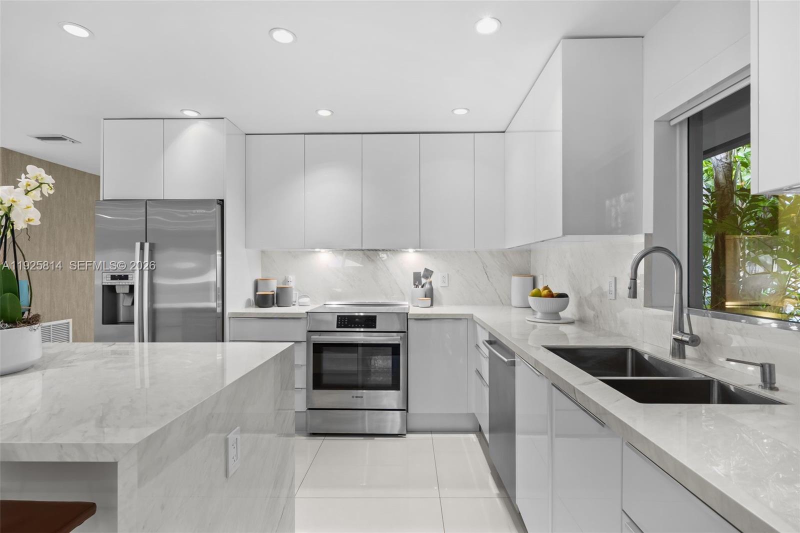 45 Southwest 19th Road Miami, FL 33129 - Photo 9 of 56 a kitchen with stainless steel appliances granite countertop a sink a stove and a refrigerator