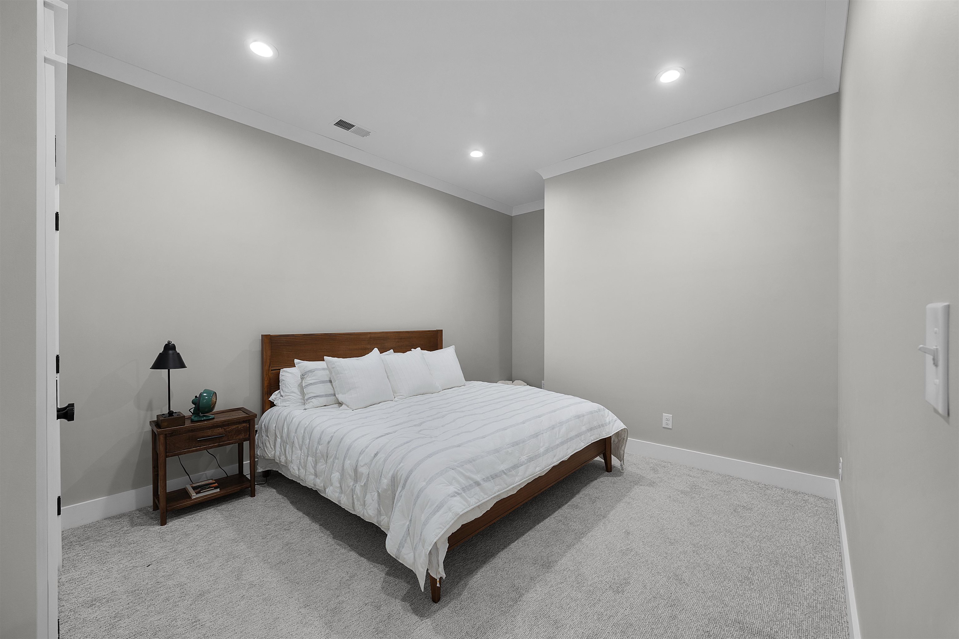 15 Daylight Cove Savannah, TN 38372 - Photo 20 of 37 a large bed sitting in a room next to a lamp