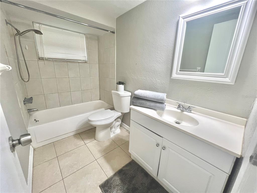 12206 Quail Run Row Hudson, FL 34667 - Photo 14 of 20 a bathroom with a sink a toilet and shower