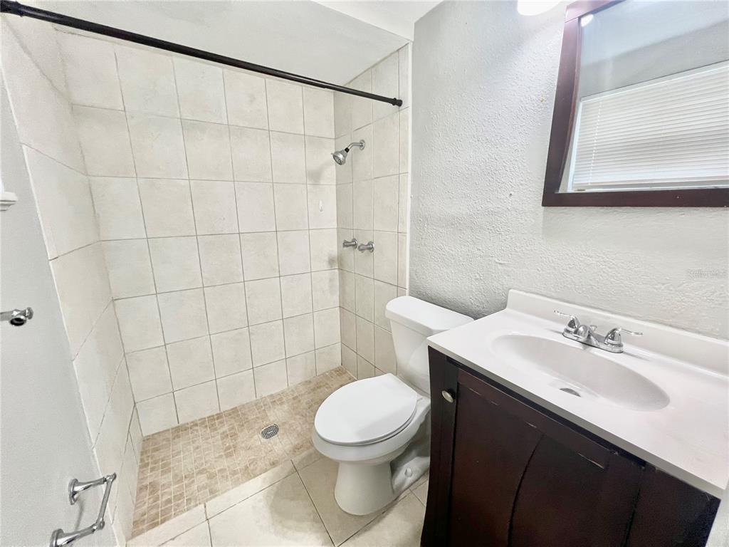 12206 Quail Run Row Hudson, FL 34667 - Photo 17 of 20 a bathroom with a sink a toilet and shower