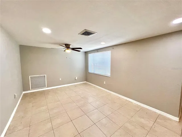 an empty room with white walls and tiles