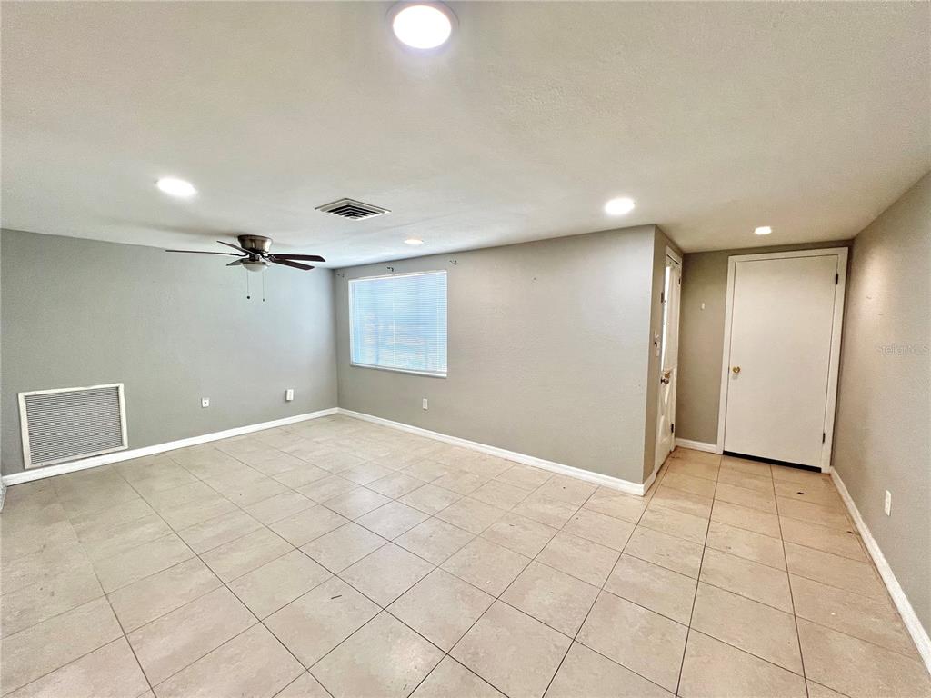 12206 Quail Run Row Hudson, FL 34667 - Photo 5 of 20 an empty room with white walls and tiles