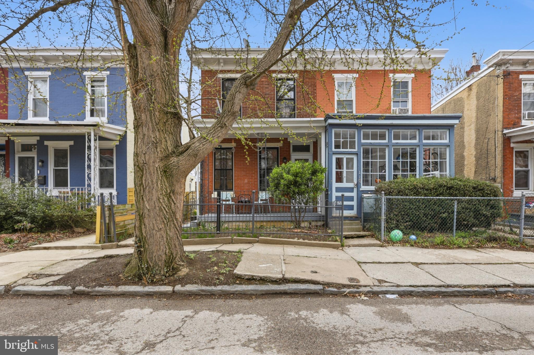 116 West Duval Street Philadelphia, PA 19144 - Photo 1 of 28 a view of a brick house with many windows next to a road