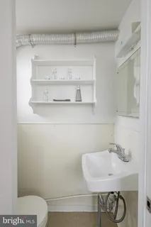 a bathroom with a toilet and a sink