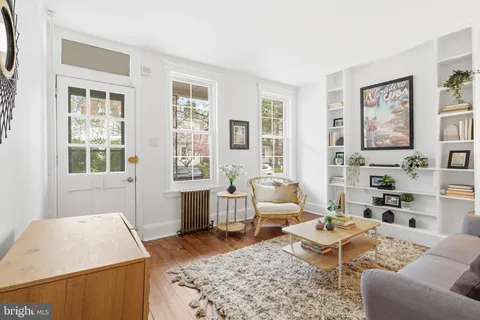 a living room with furniture rug and window