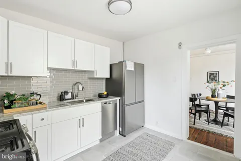 a kitchen with stainless steel appliances granite countertop a refrigerator sink and stove