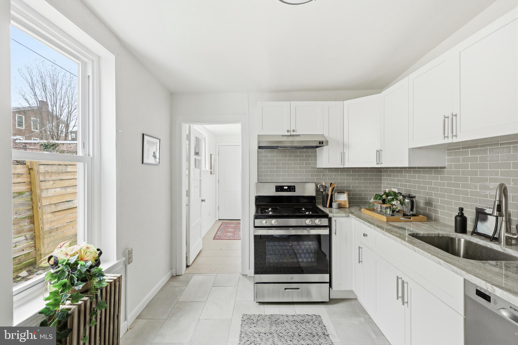 116 West Duval Street Philadelphia, PA 19144 - Photo 10 of 28 a kitchen with stainless steel appliances a stove a sink a refrigerator and cabinets