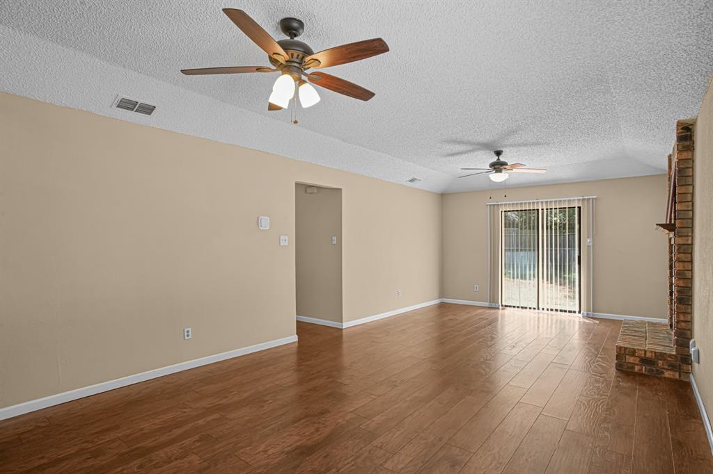 2134 Reverchon Drive Arlington, TX 76017 - Photo 4 of 23 Lovely flooring throught the home, nice neture color to match decor.