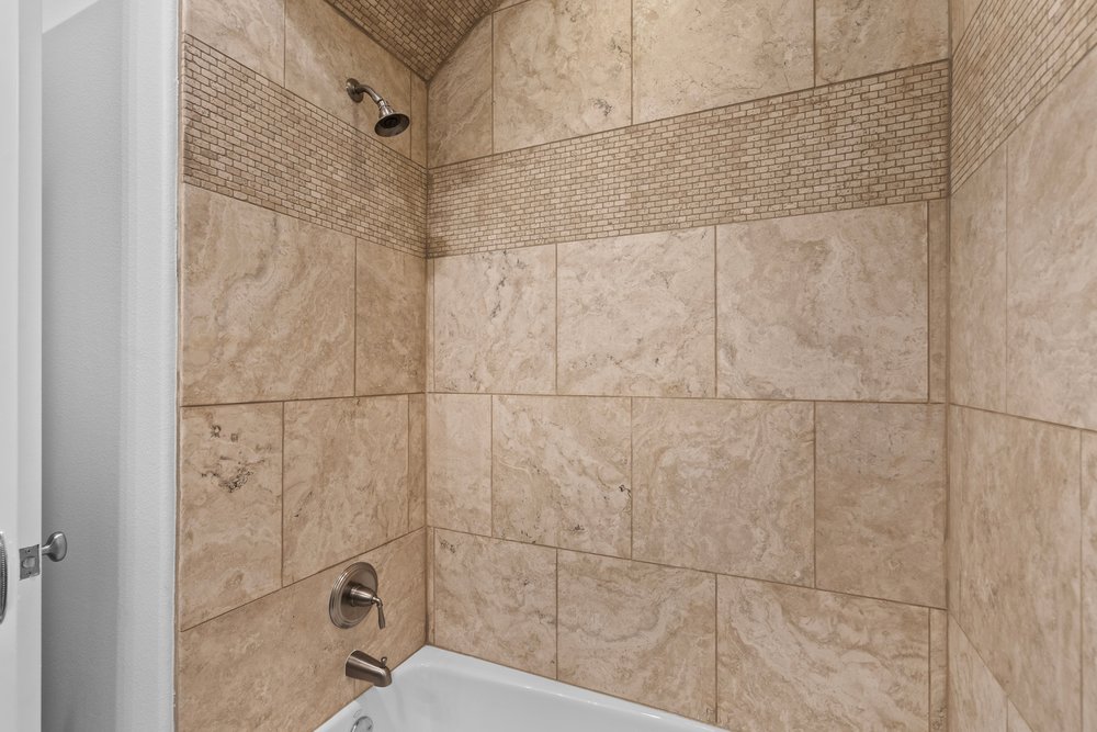 1609 Hartford Road, Unit A Austin, TX 78703 - Photo 38 of 39 Natural stone tilework creates a soothing bath environment.