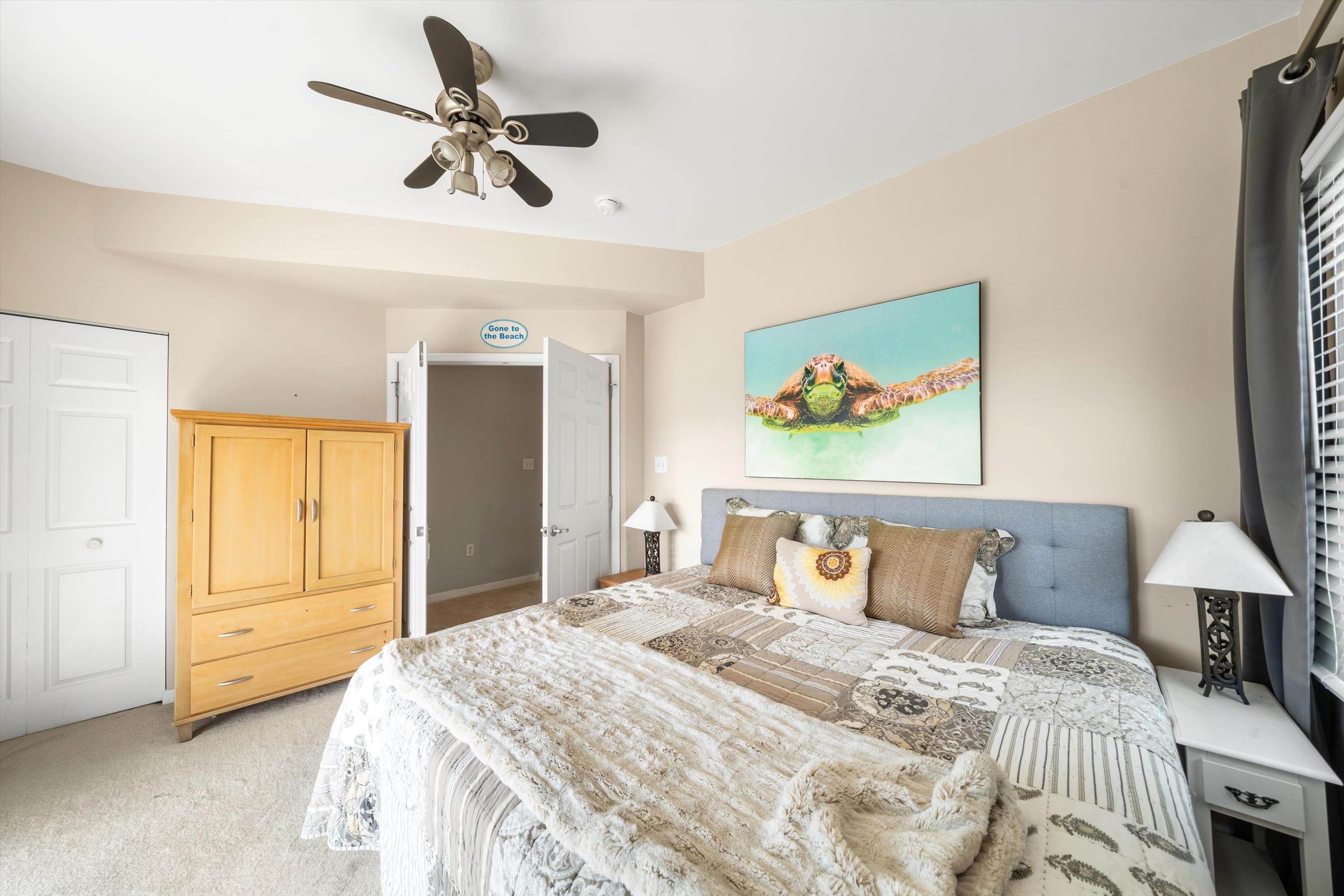 352 46th Place, Unit EAST Sea Isle City, NJ 08243 - Photo 24 of 40 a bedroom with a bed and a chandelier