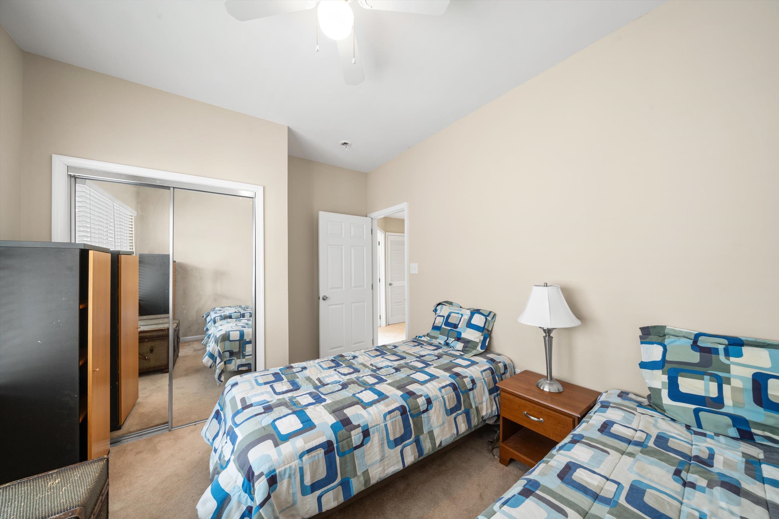 352 46th Place, Unit EAST Sea Isle City, NJ 08243 - Photo 28 of 40 a bedroom with a bed and a table in it