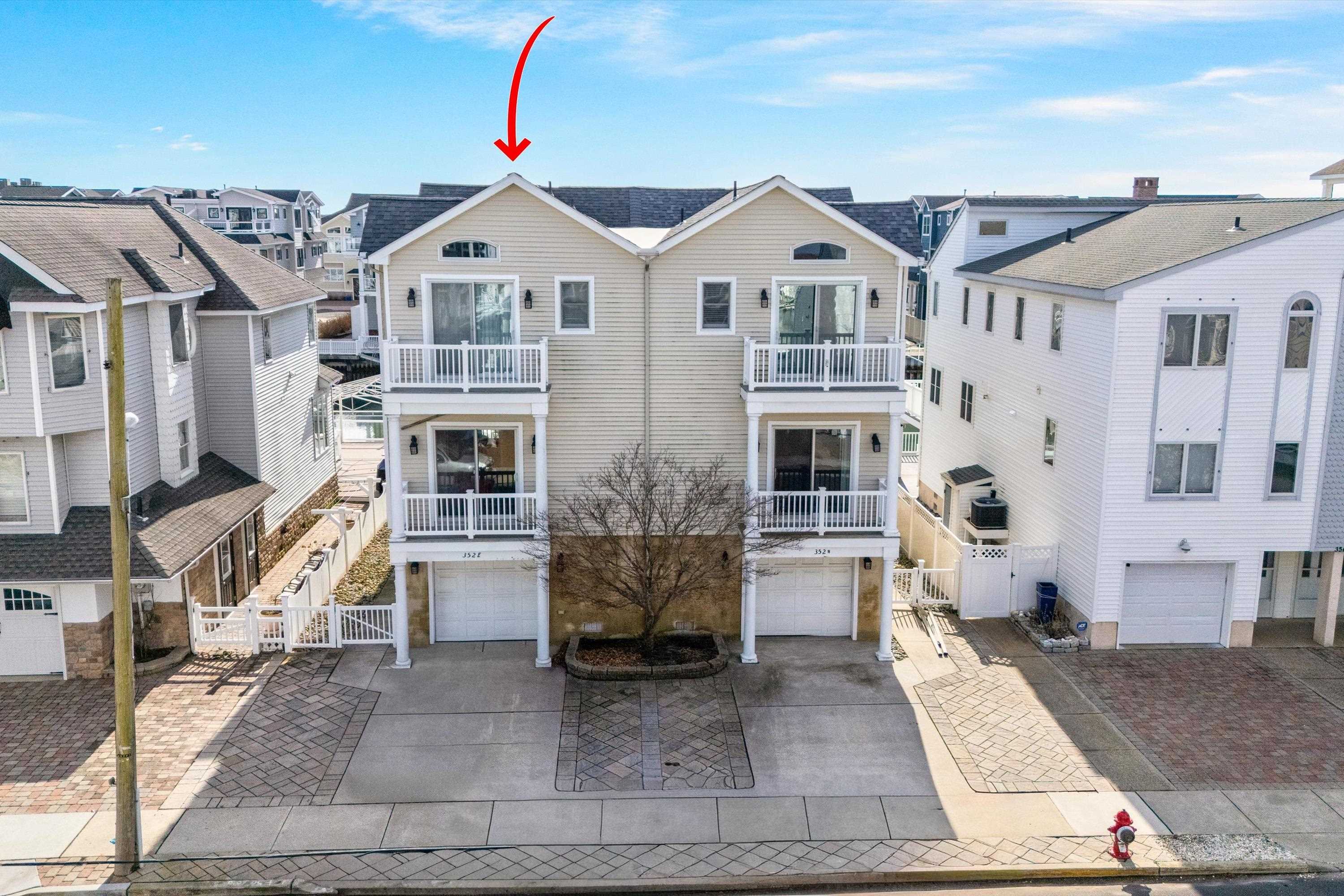 352 46th Place, Unit EAST Sea Isle City, NJ 08243 - Photo 39 of 40 a front view of a house with a yard