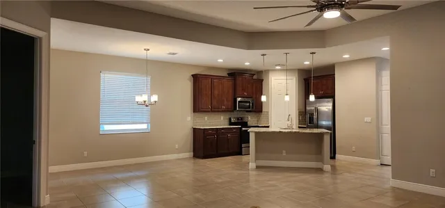 a view of a kitchen with a sink and a refrigerator