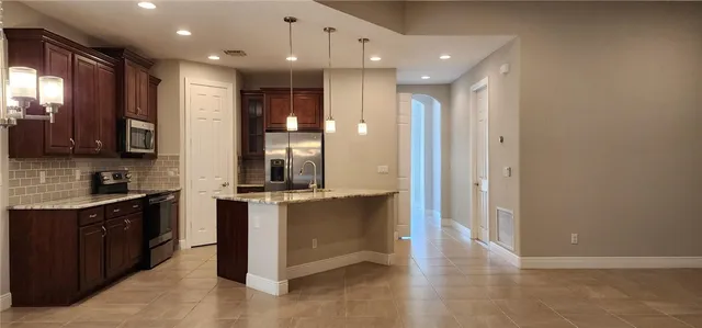 a kitchen with stainless steel appliances granite countertop a stove and a sink