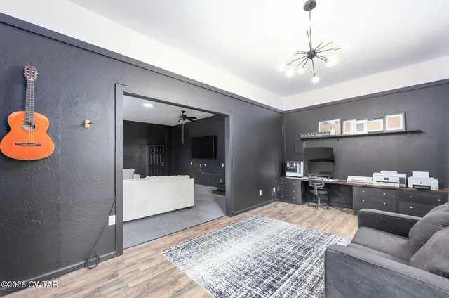 a view of room with closet and flat screen tv