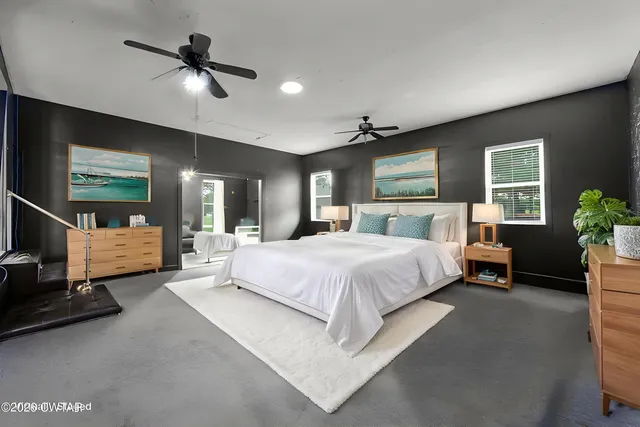 a bedroom with a bed and a potted plant