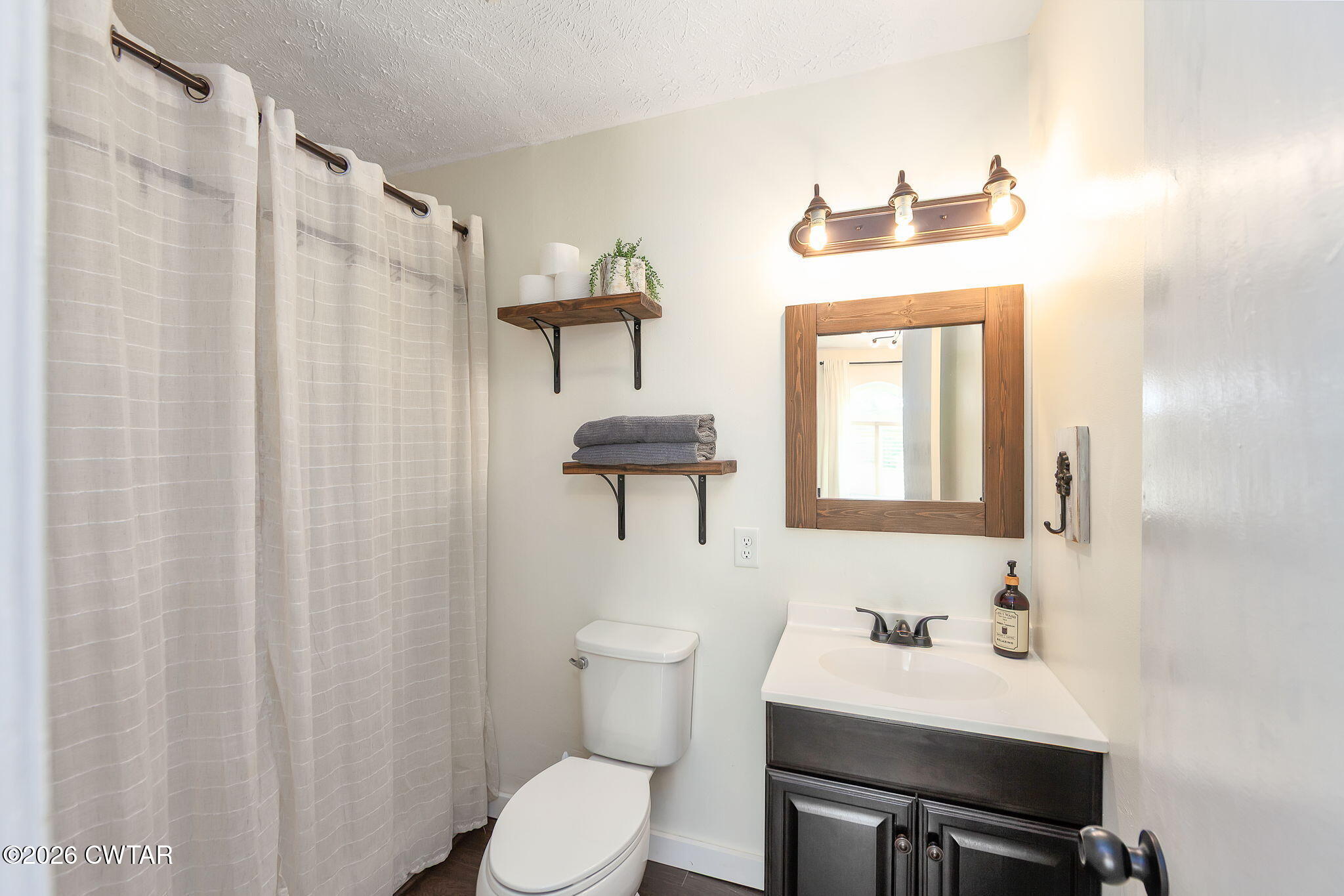815 Trice Road Henderson, TN 38340 - Photo 20 of 34 a bathroom with a sink vanity mirror and toilet