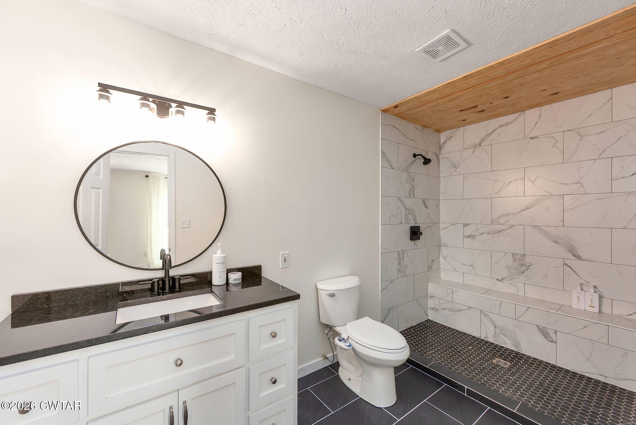 815 Trice Road Henderson, TN 38340 - Photo 24 of 34 a bathroom with a toilet a sink and mirror
