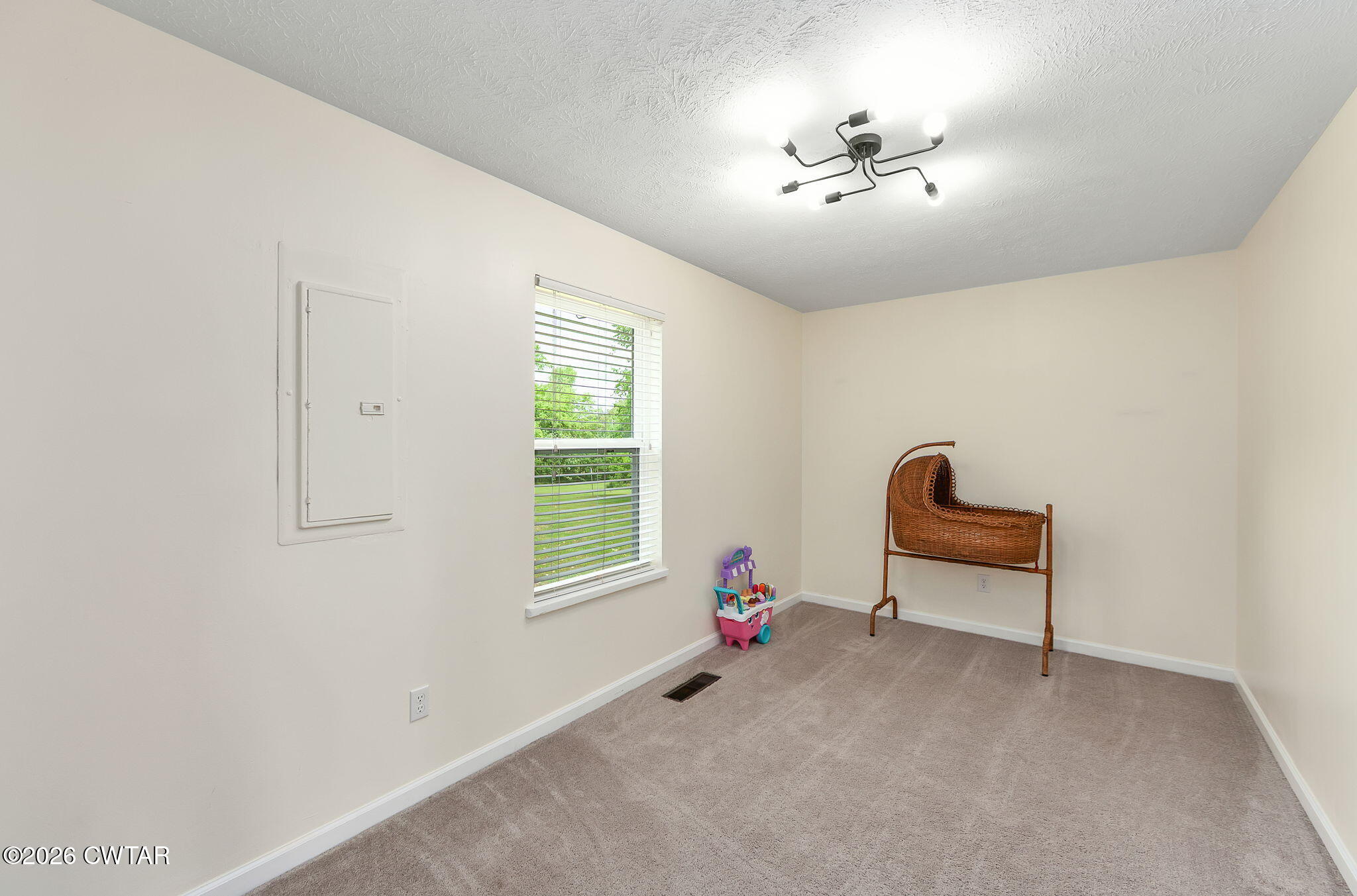 815 Trice Road Henderson, TN 38340 - Photo 25 of 34 an empty room with windows and ceiling fan