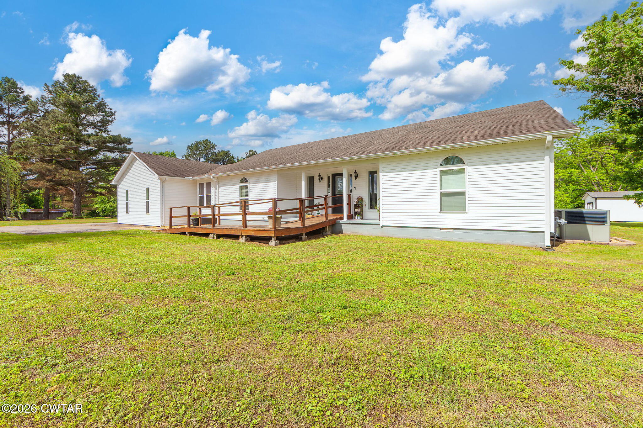 815 Trice Road Henderson, TN 38340 - Photo 27 of 34 a house view with swimming pool and trees in the background
