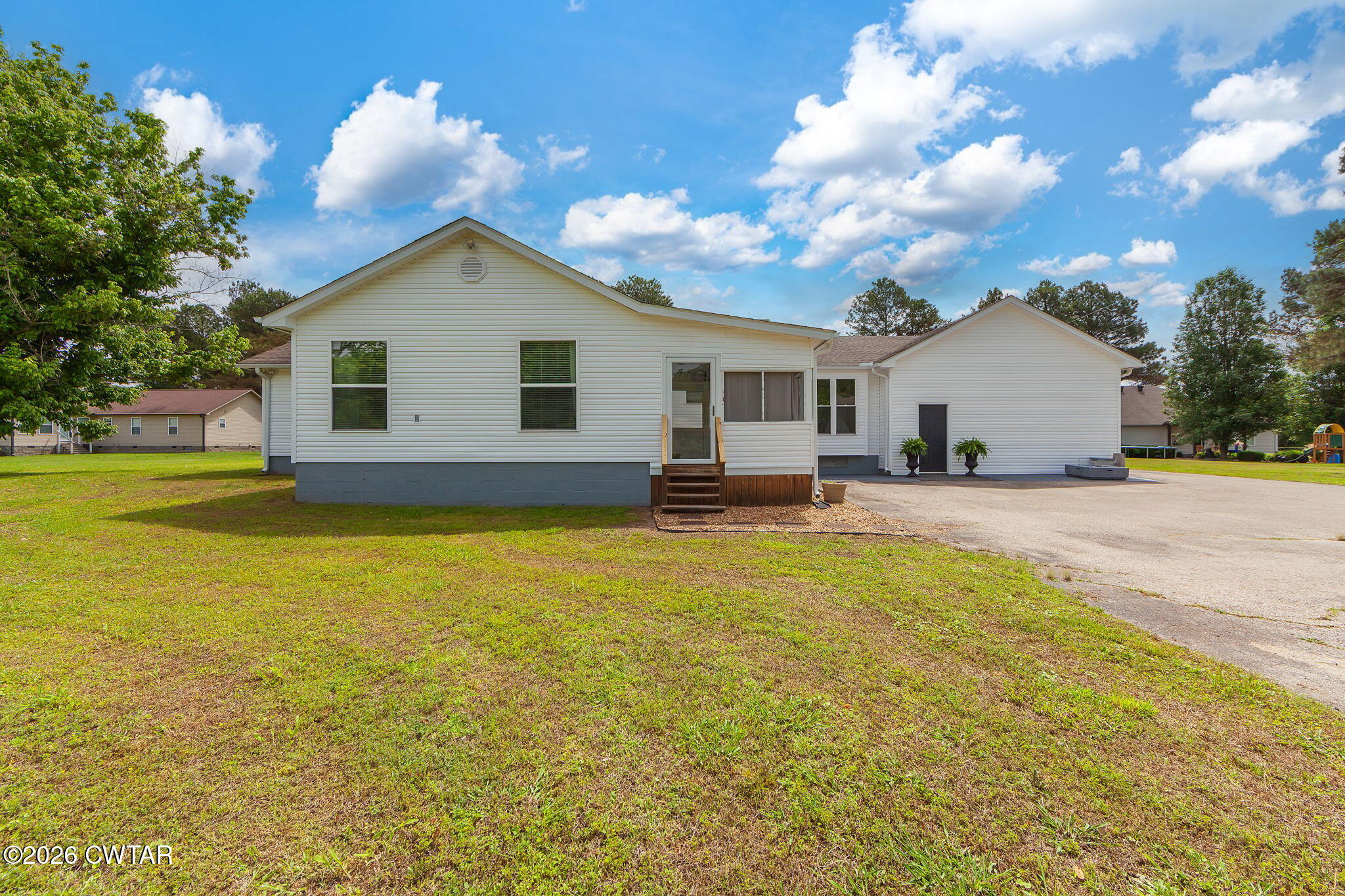 815 Trice Road Henderson, TN 38340 - Photo 30 of 34 a house view with swimming pool and trees in the background