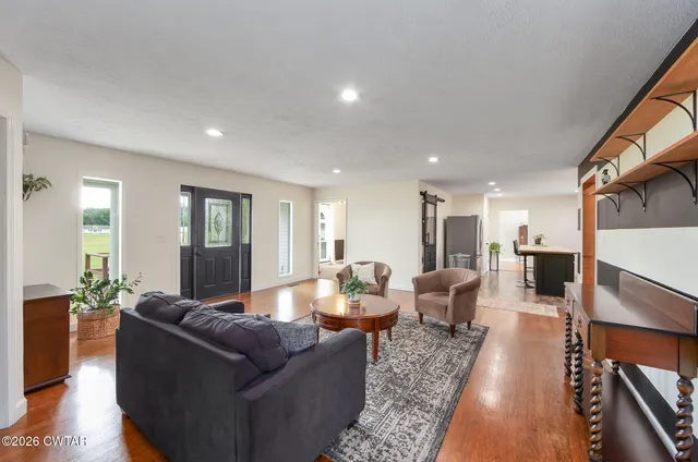 a large kitchen with lots of counter space and wooden floor