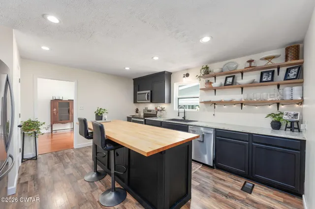 a dining room with furniture window and wooden floor