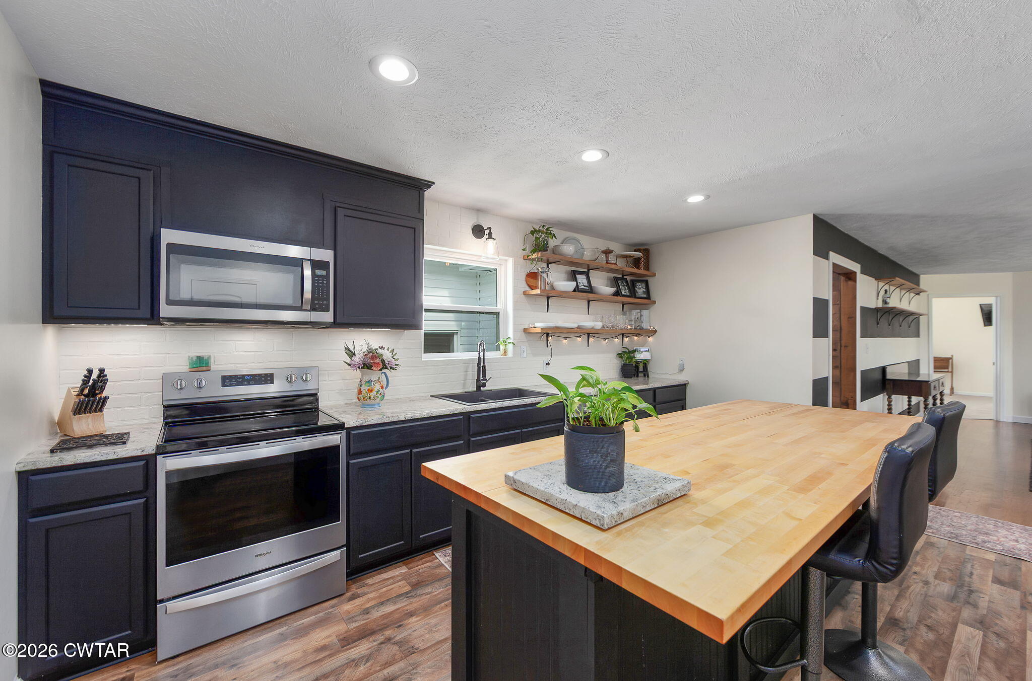 815 Trice Road Henderson, TN 38340 - Photo 6 of 34 a kitchen with a stove a sink and a microwave