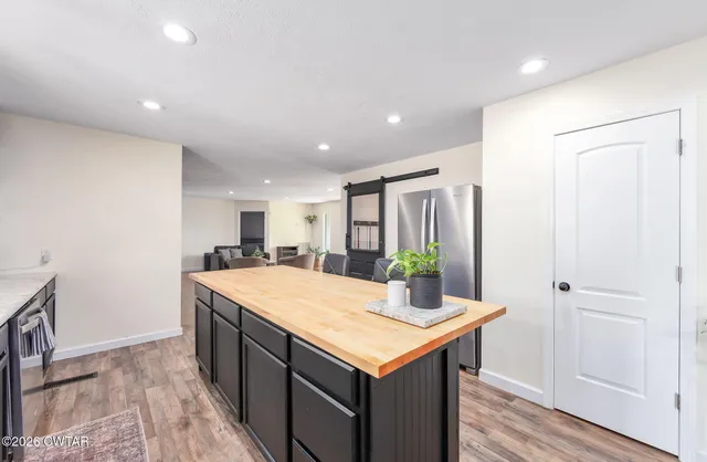 a living room with furniture and a ceiling fan