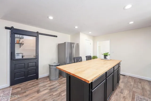 a spacious bedroom with a bed and a chandelier