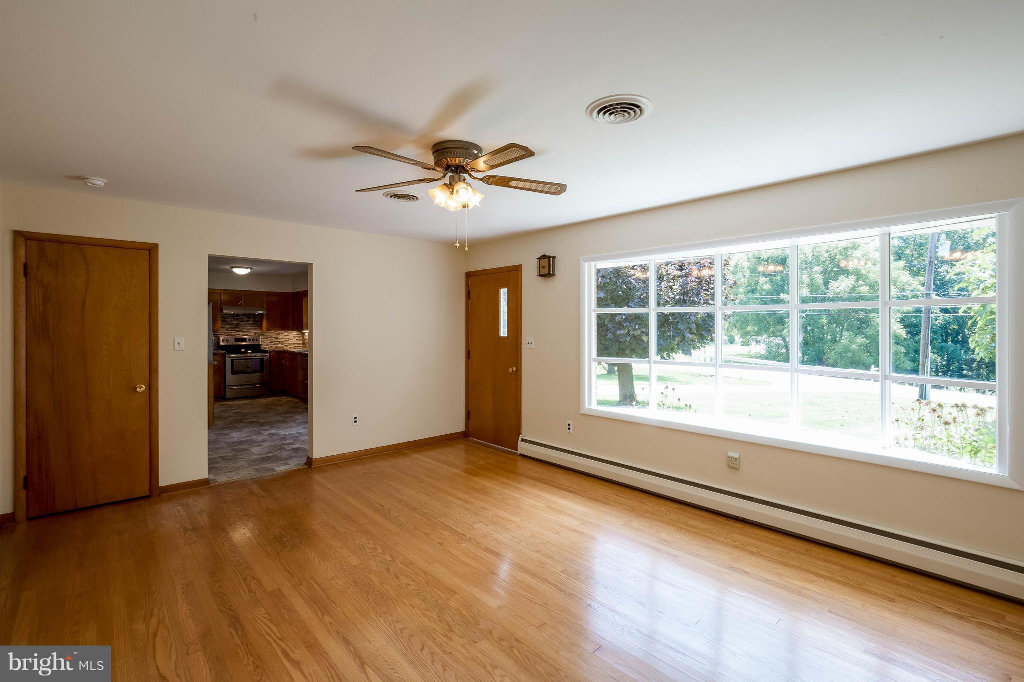 3430 Hampstead Mexico Road Hampstead, MD 21074 - Photo 6 of 28 Living Room also has a hardwood floor.