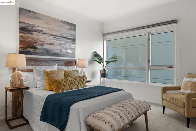 a bedroom with a bed and a couch