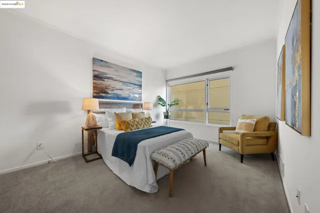 a bedroom with bed couch and window