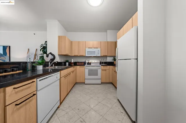 a kitchen with white cabinets and white appliances