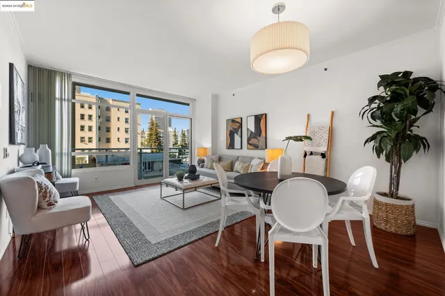 a living room with furniture a table and large windows